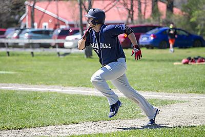 Landmark College baseball player heads for first base.